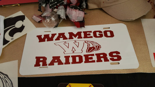 Wamego Raiders in Red Glitter on a White License Plate